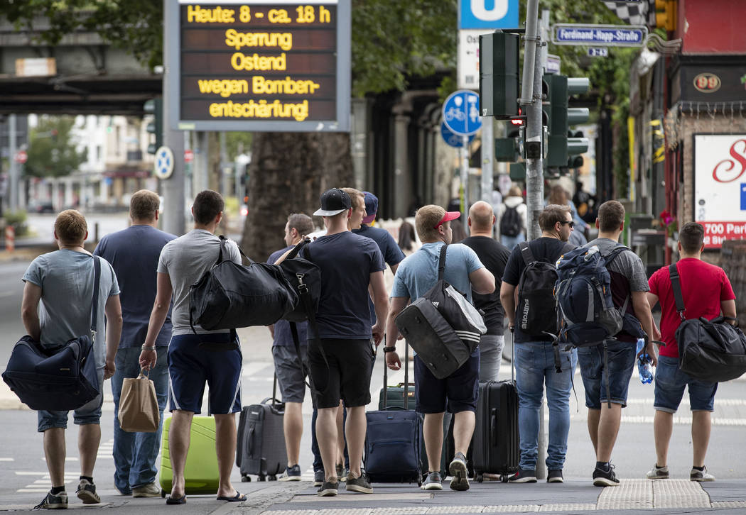 People leave the forbidden area near the European Central Bank as 16 000 people are evacuated p ...