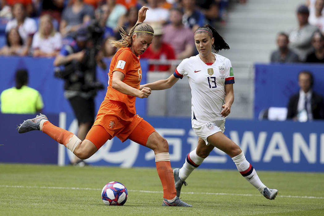 Netherlands' Anouk Dekker, left, is challenged by United States' Emily Sonnett during the Women ...