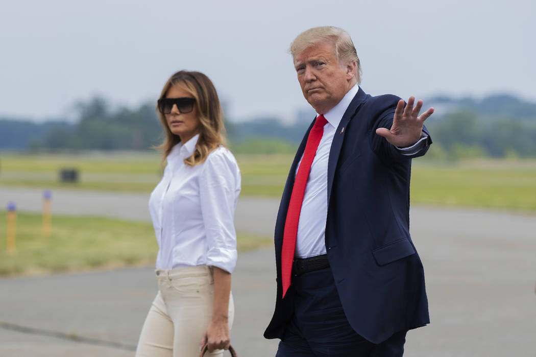 President Donald Trump and first lady Melania Trump, walk on the tarmac upon arrival at Morrist ...