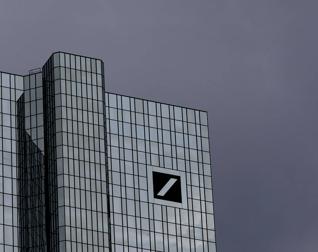 Dark clouds cover the sky over the headquarter of Deutsche Bank in Frankfurt, Germany, Sunday, ...