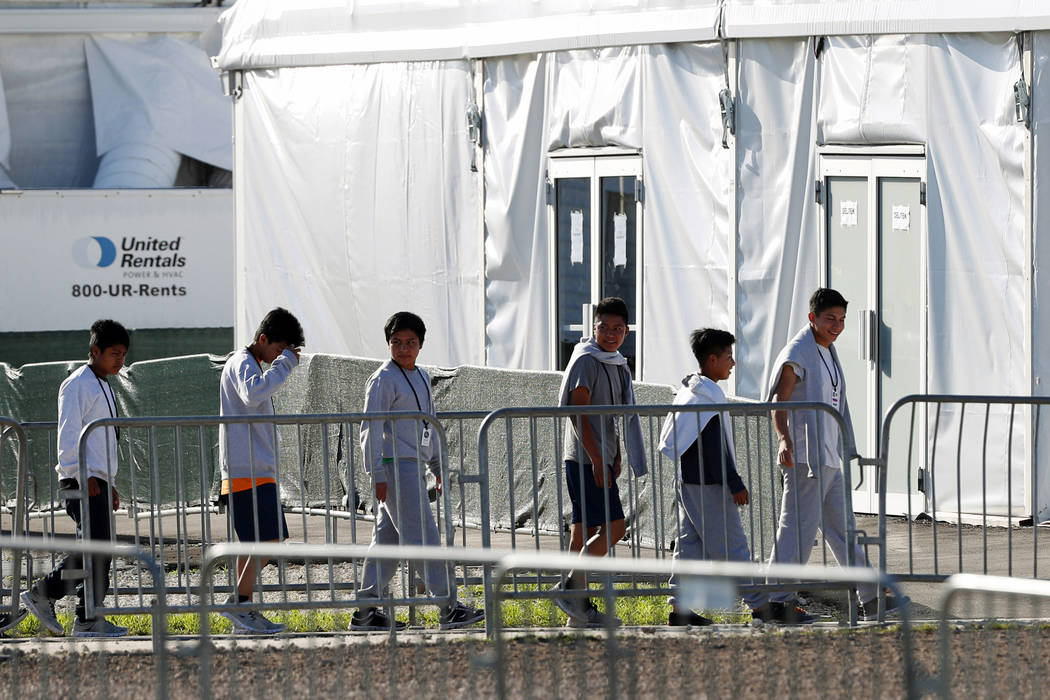 FILE - In this Feb.19, 2019 file photo, children line up to enter a tent at the Homestead Tempo ...