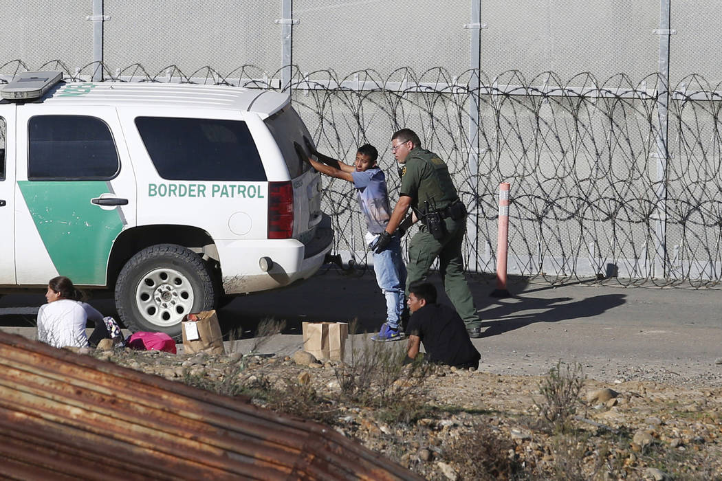 FILE - In this Dec. 15, 2018, file photo, Honduran asylum seekers are taken into custody by U.S ...