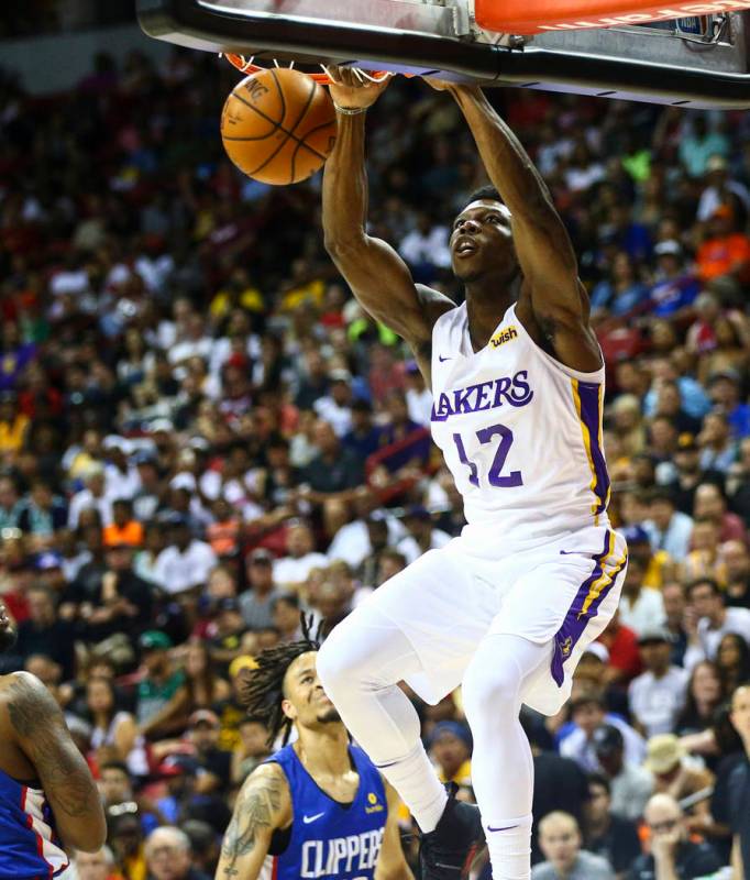 Los Angeles Lakers' Devontae Cacok (12) dunks against the Los Angeles Clippers during the first ...