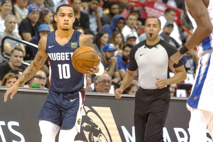 Denver Nuggets' Jordan Davis (10) brings the ball up court against the Orlando Magic during a b ...