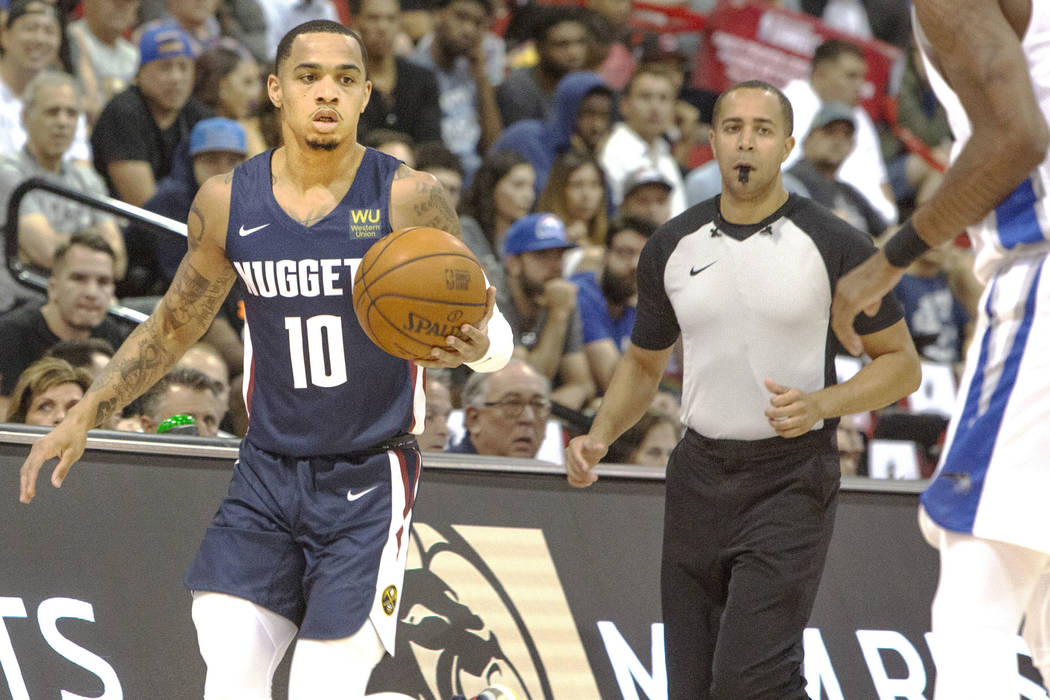 Denver Nuggets' Jordan Davis (10) brings the ball up court against the Orlando Magic during a b ...