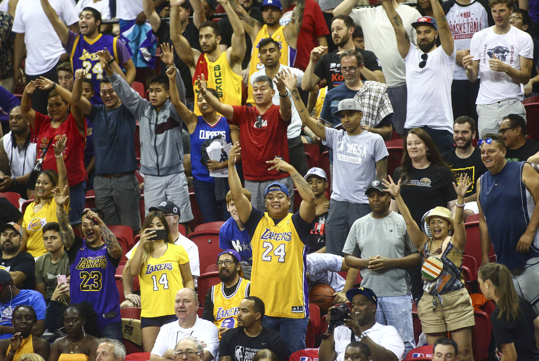 Basketball fans cheer for free items during a game between the Los Angeles Lakers and the Los A ...