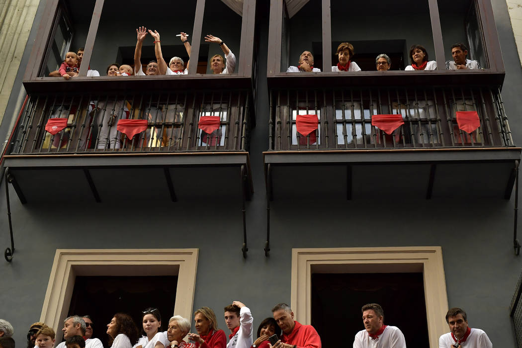 People wait ahead of the running of the bulls at the San Fermin Festival, in Pamplona, northern ...