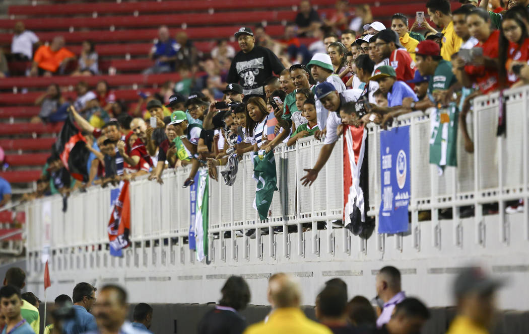 Soccer fans cheer as plays from Leon and Tijuana enter the field for an exhibition soccer match ...