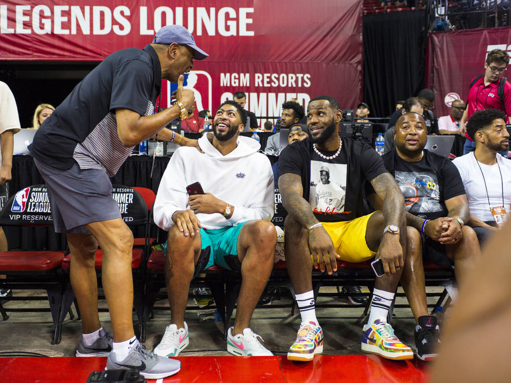 Los Angeles Lakers' Anthony Davis, second from left, and LeBron James mingle with people courts ...