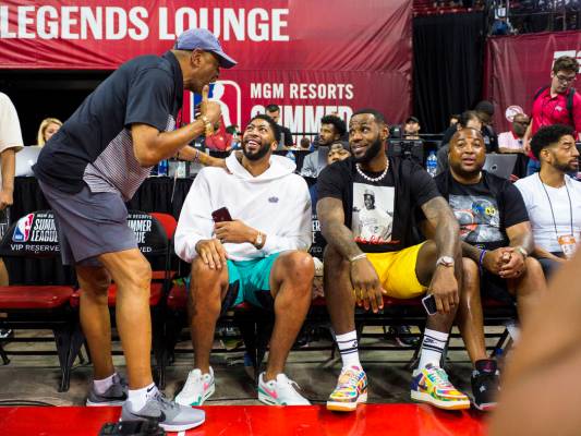 Los Angeles Lakers' Anthony Davis, second from left, and LeBron James mingle with people courts ...