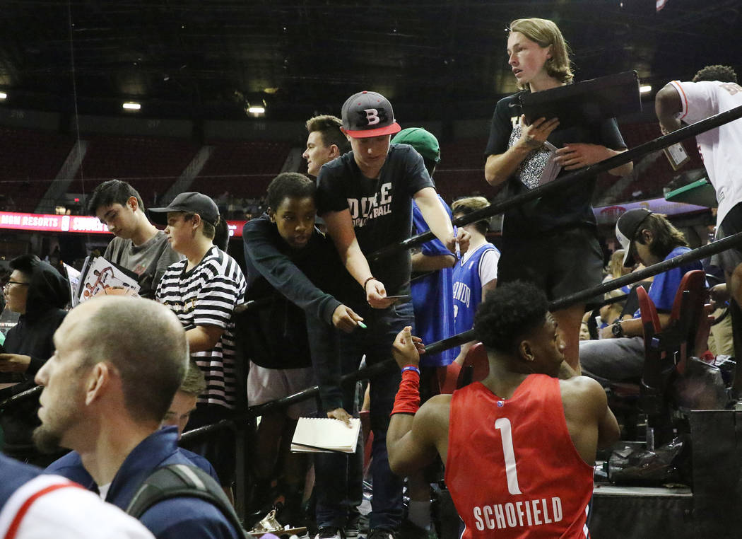 The Washington Wizards' forward Admiral Schofield (1) signs autograph after playing against the ...