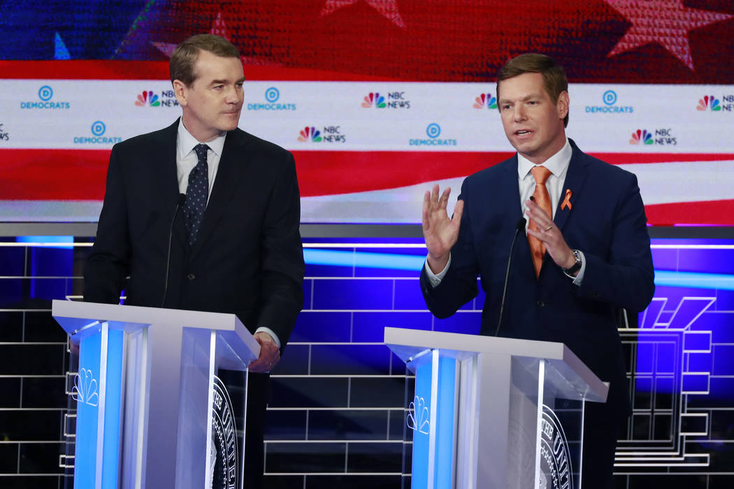 Democratic presidential candidate Rep. Eric Swalwell, D-Calif., right, speaks during the Democr ...