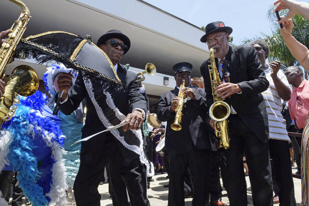 The Treme brass band and attendees dance after pallbearers carried the coffin of Dave Bartholom ...