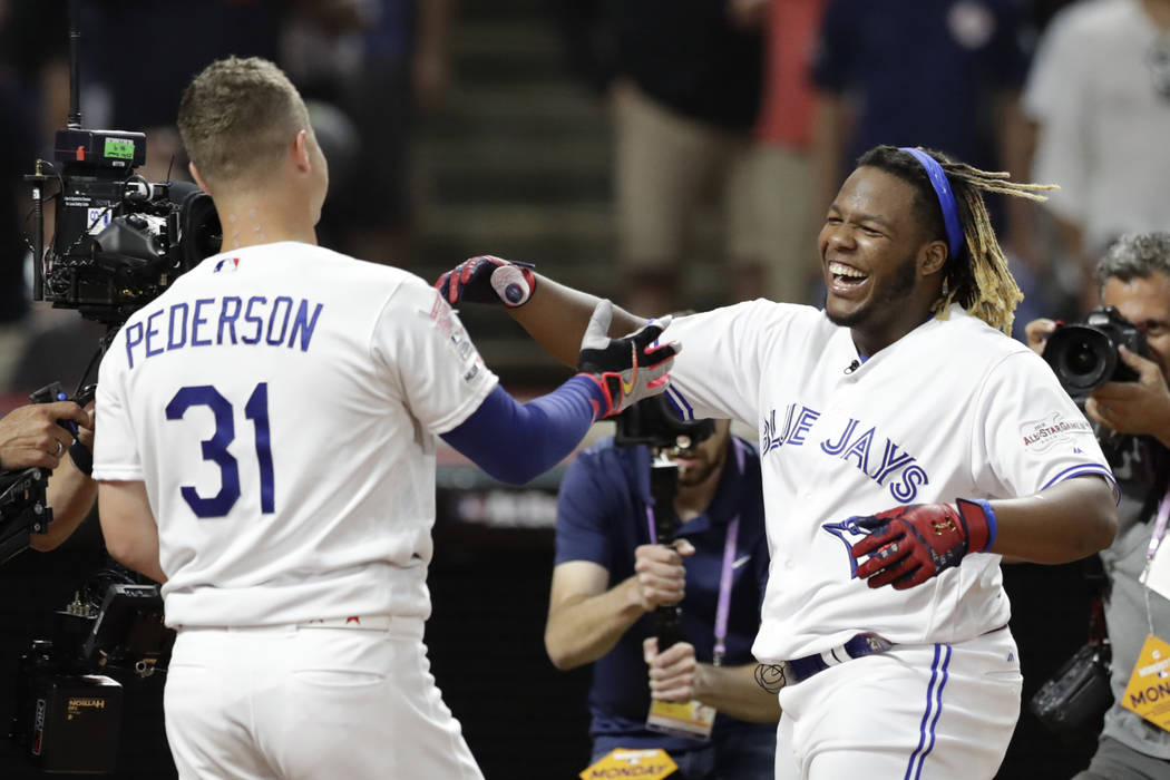 Vladimir Guerrero Jr., right, of theToronto Blue Jays, is congratulated by Joc Pederson, of the ...