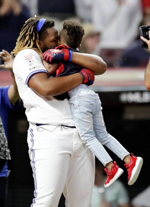 Vladimir Guerrero Jr., of the Toronto Blue Jays, holds the son of Ketel Marte, of the Arizona D ...