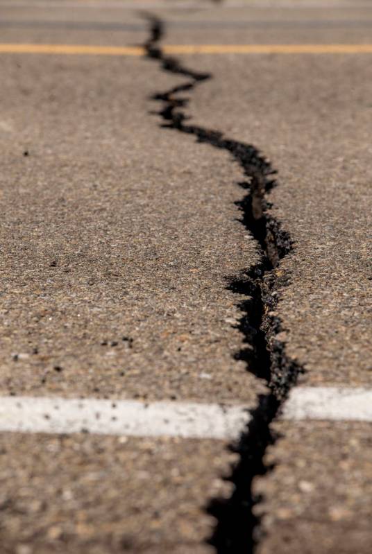 Caltrans workers continue to monitor the extensive cracks with shifting pavement that have open ...