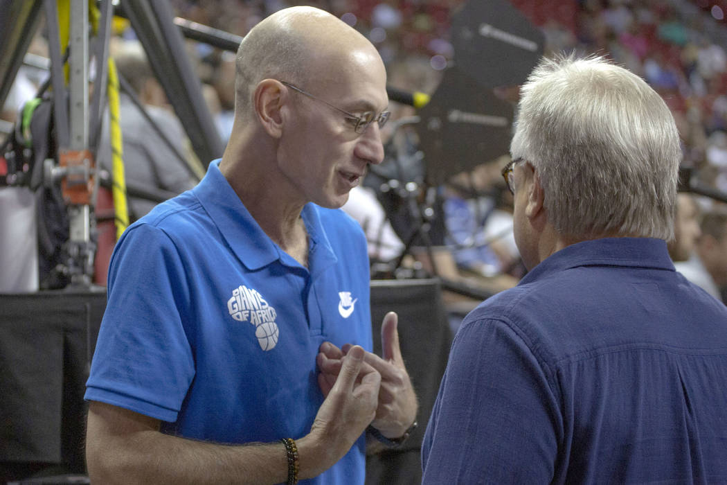 NBA Commissioner Adam Silver, left, talks to Warren LeGarie, Summer League executive director, ...