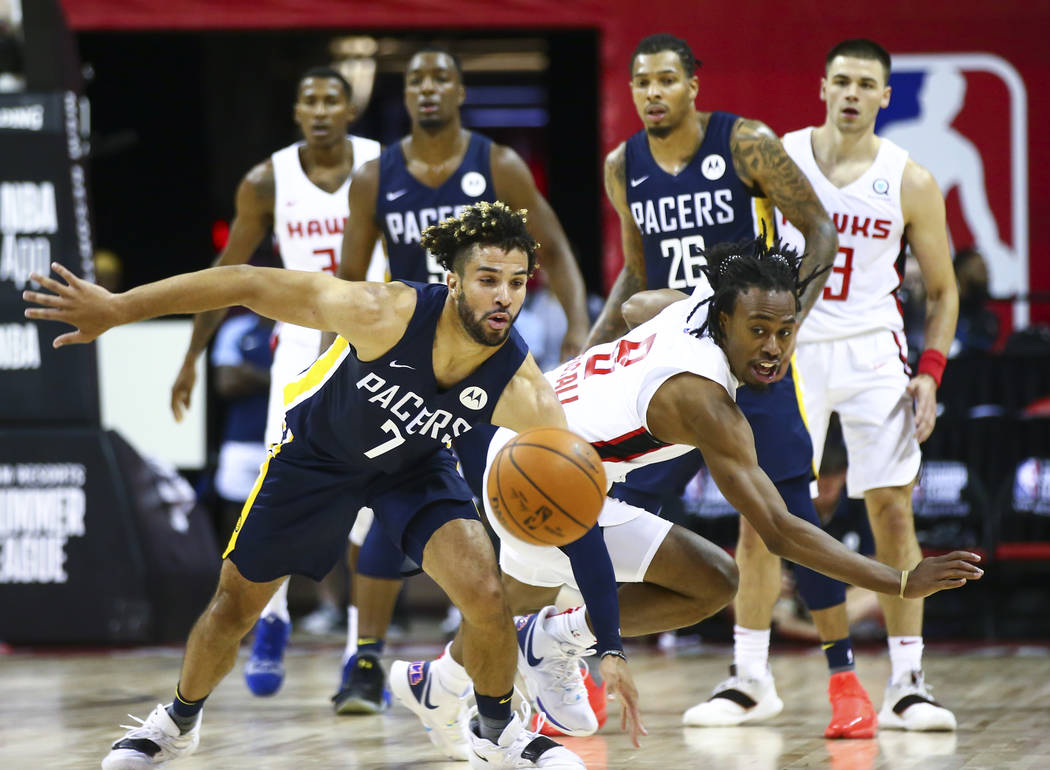 Indiana Pacers' Cody Demps (7) battles for a loose ball against Atlanta Hawks' Tahjere McCall ( ...