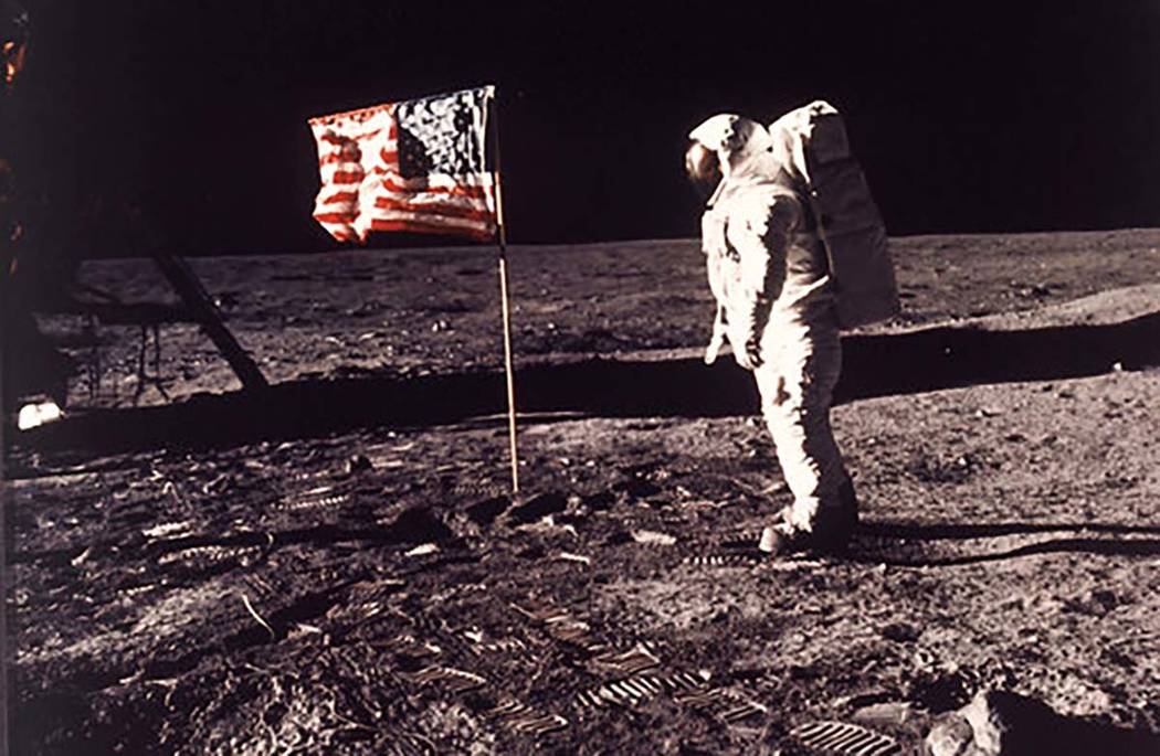 In this image provided by NASA, astronaut Buzz Aldrin poses for a photograph beside the U.S. fl ...