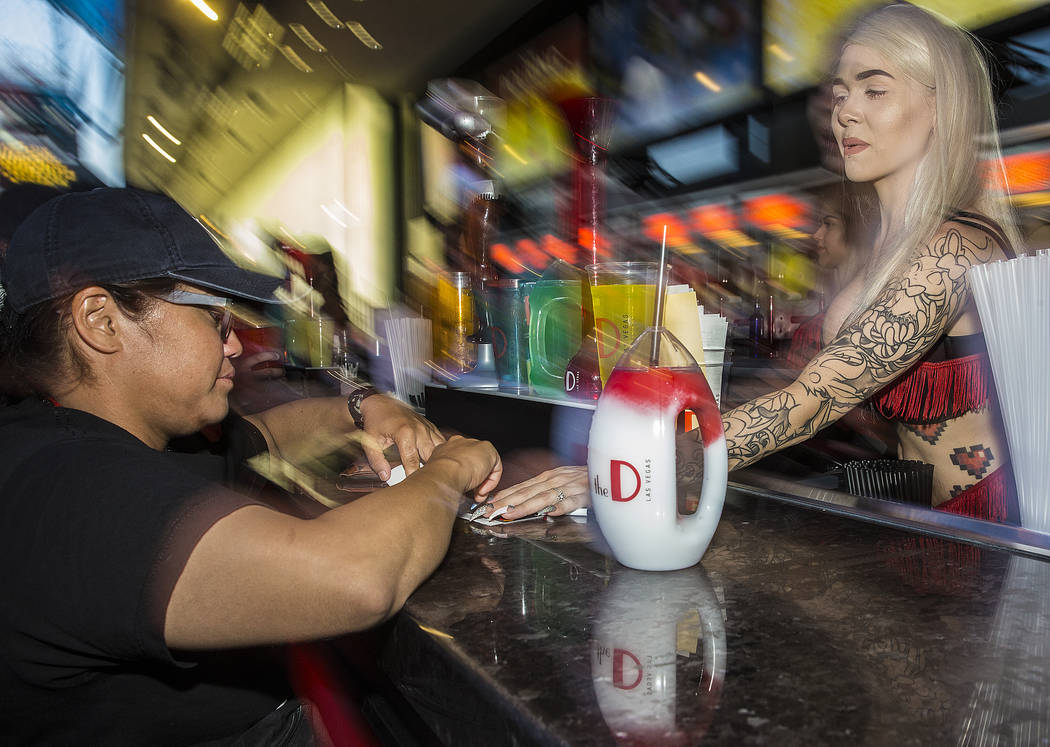 Bartender Hunter Cox, right, serves Kiro Murashige a tropical bliss frozen drink on Friday, Jul ...