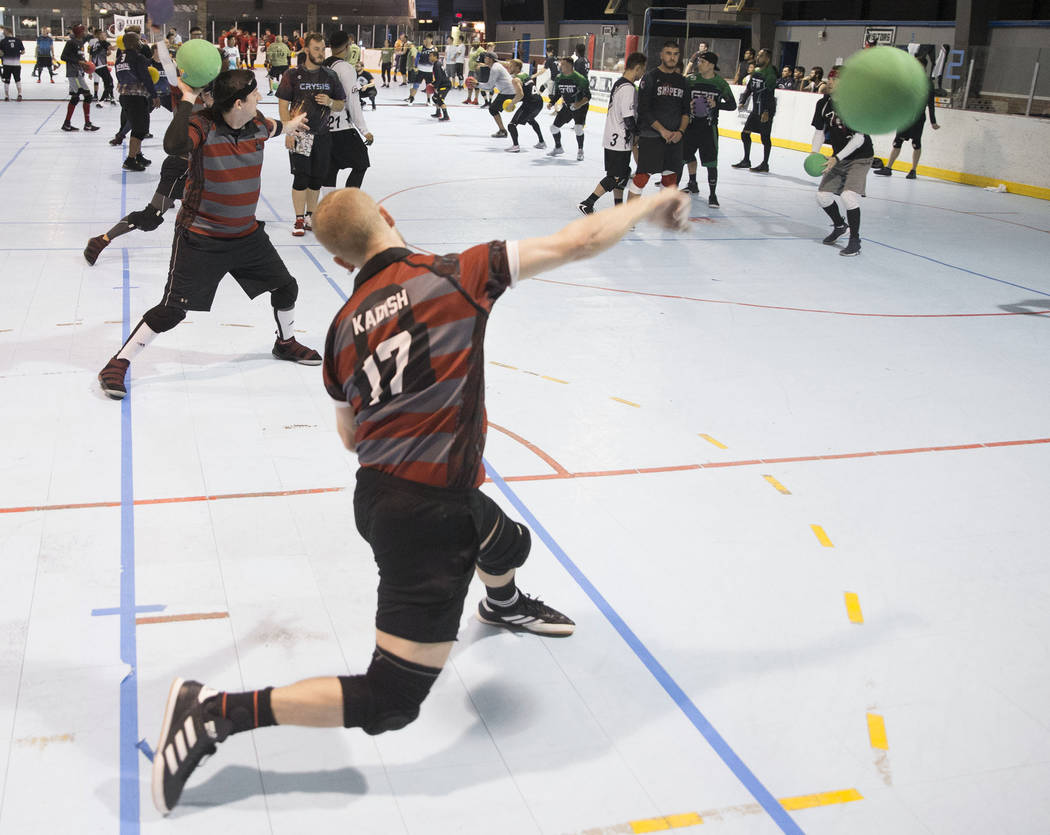 Josh Kadish, front/left, of team Gridlock attacks during a two-day, five-division dodgeball tou ...