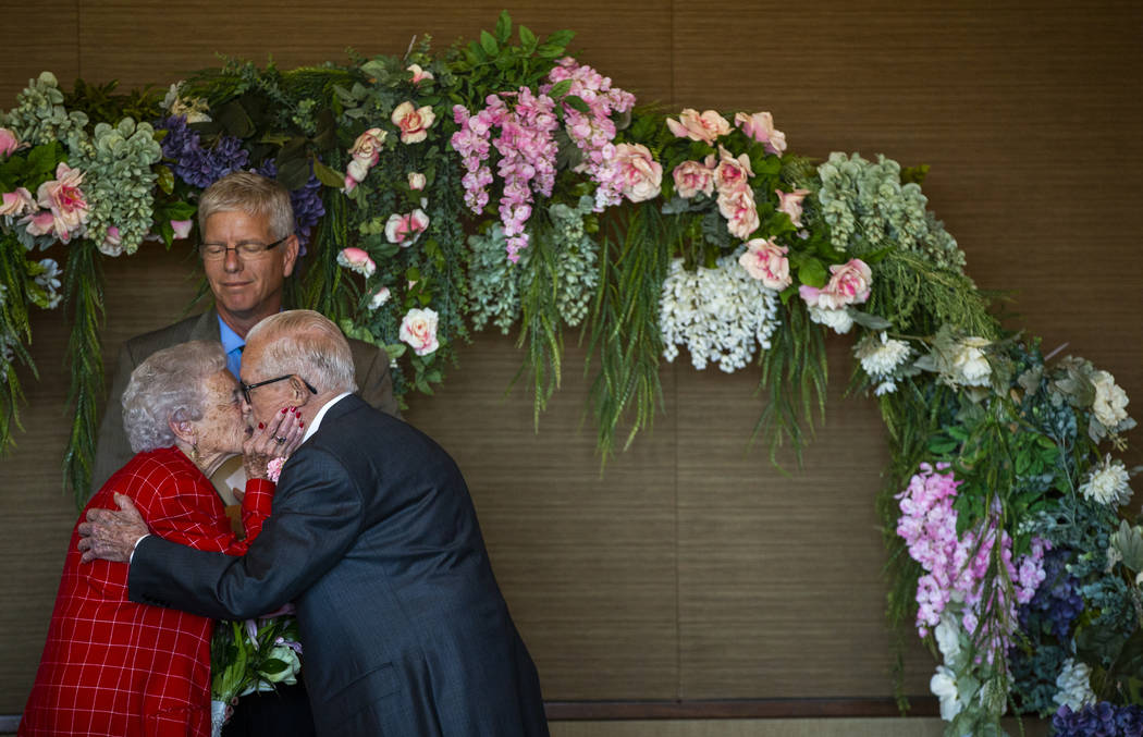 Donna Andress kisses her husband, Gail, right, as Deacon Tim O'Callaghan presides during a rene ...