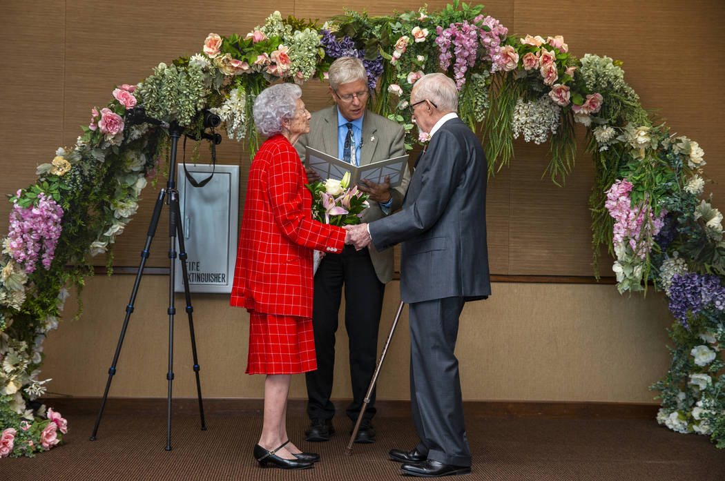 Donna Andress, left, looks to husband Gail, right, as Deacon Tim O'Callaghan presides during a ...