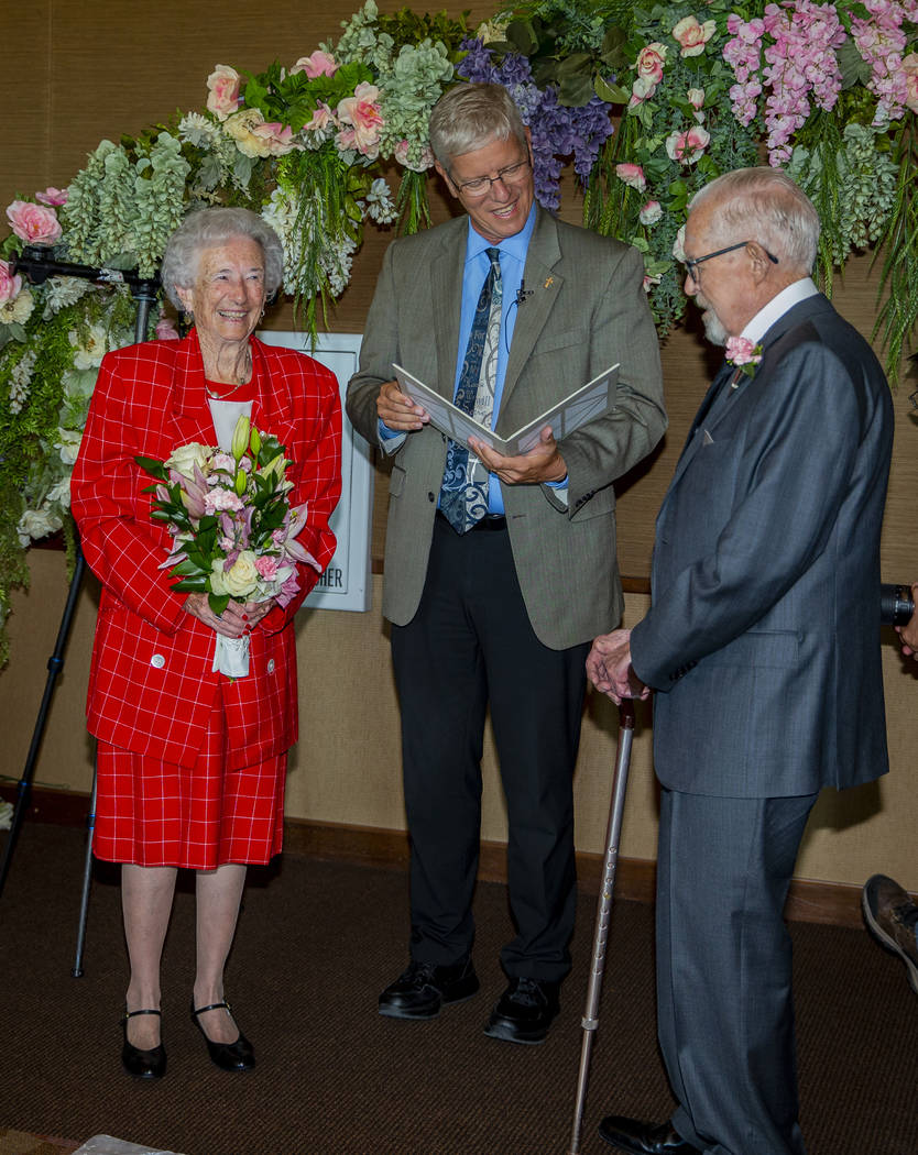 Donna Andress, left, looks to husband Gail, right, as Deacon Tim O'Callaghan presides during a ...