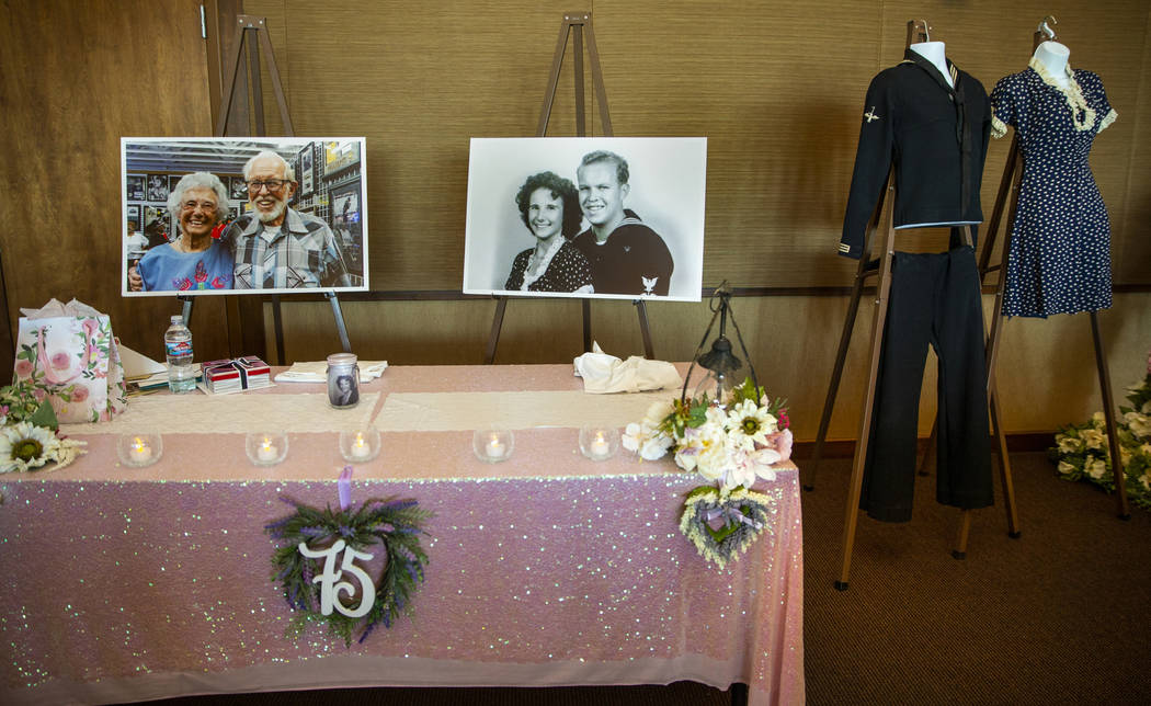 Photos of Gail and Donna Andress and their original wedding outfits on display during a renewal ...