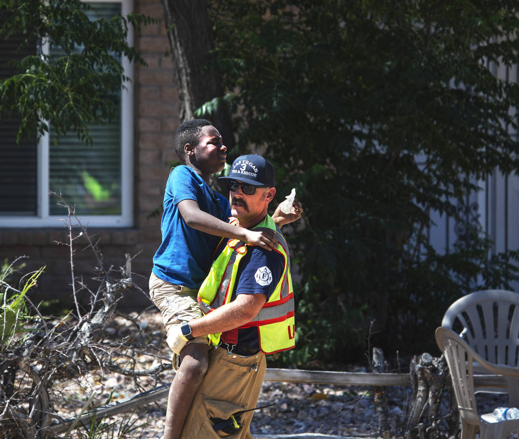 A firefighter carries one of the children injured in a crash on West Washington Avenue near Dec ...