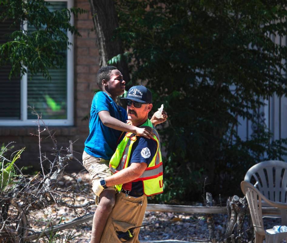 A firefighter carries one of the children injured in a crash on West Washington Avenue near Dec ...