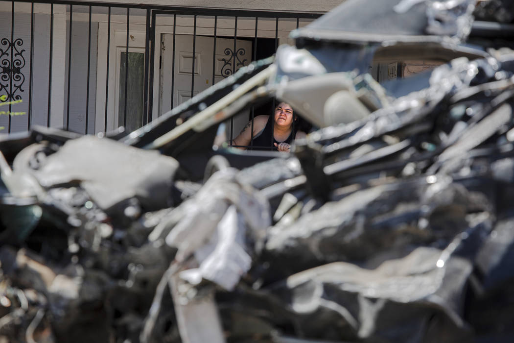 A resident looks at the scene of a fatal crash on West Washington Avenue near Decatur Boulevard ...