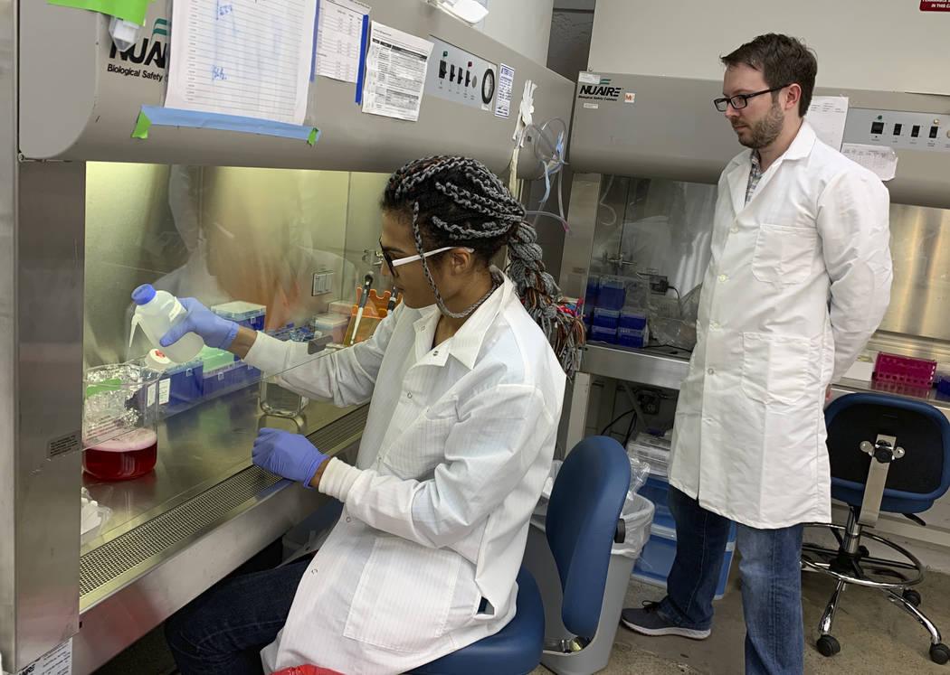 In this photo taken Feb. 15, 2019, lab automation engineer Chigozie Nri prepares nutrients to f ...