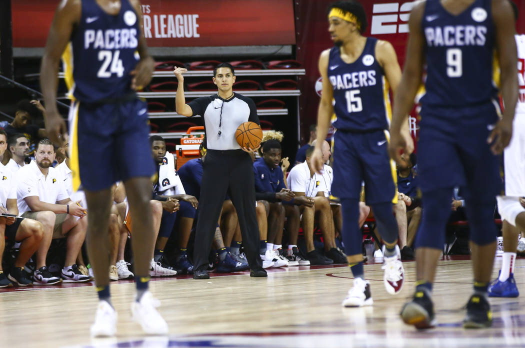 Referee Omar Bermudez, center, motions while officiating a game between Atlanta Hawks and India ...