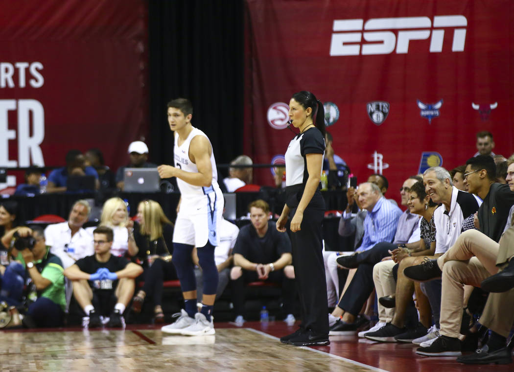 Referee Hortencia Sanchez-Carrizales, center right, officiates a game between Phoenix Suns and ...