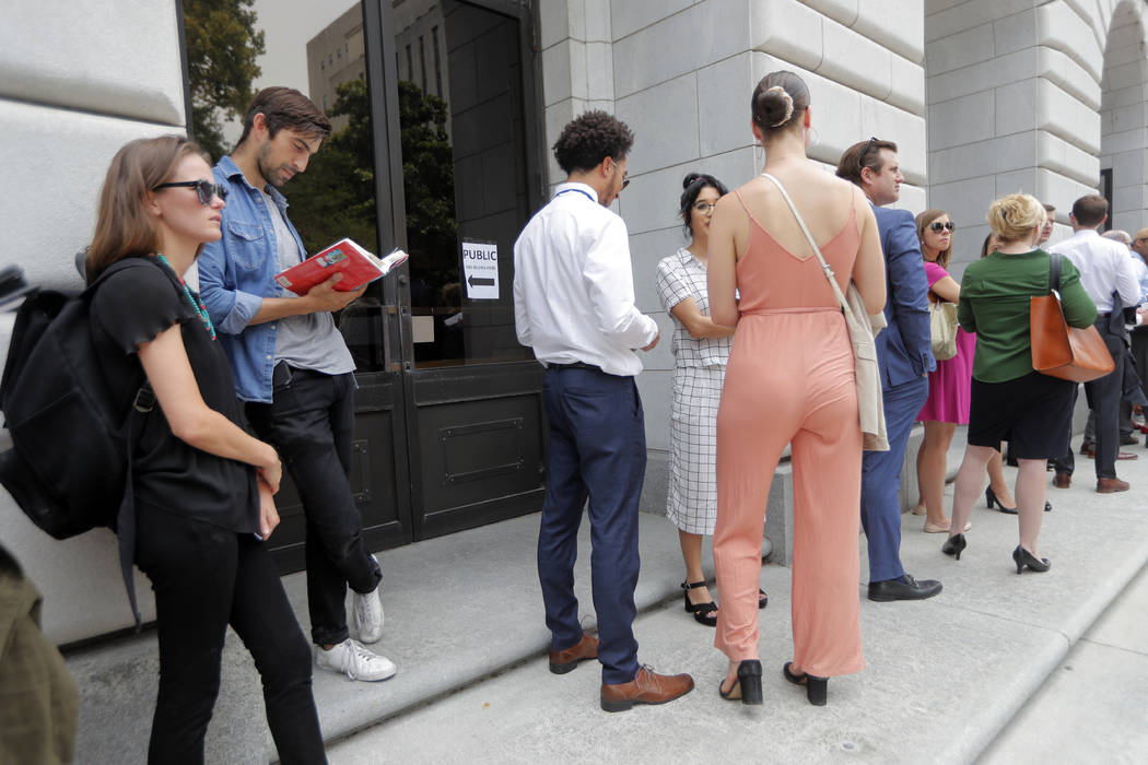 People wait in line to enter the 5th Circuit Court of Appeals to sit in overflow rooms to hear ...