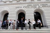 People wait in line to enter the 5th Circuit Court of Appeals to sit in overflow rooms to hear ...