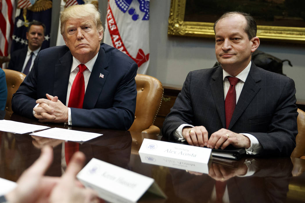 President Donald Trump, left, and Labor Secretary Alexander Acosta listen during a meeting of t ...