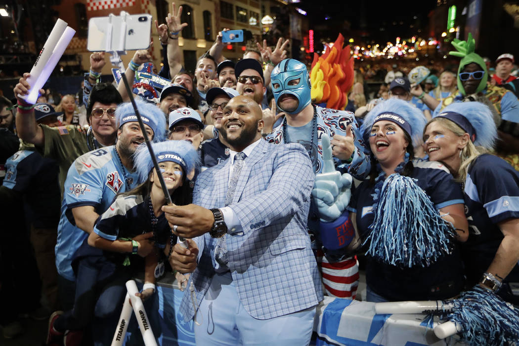 Tennessee Titans player Jurrell Casey takes a photo with fans on the main stage after announcin ...