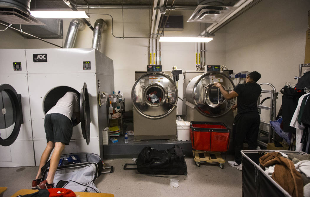 UNLV students Devin James, left, and Wesley Wharton work on organizing clothes for NBA teams in ...