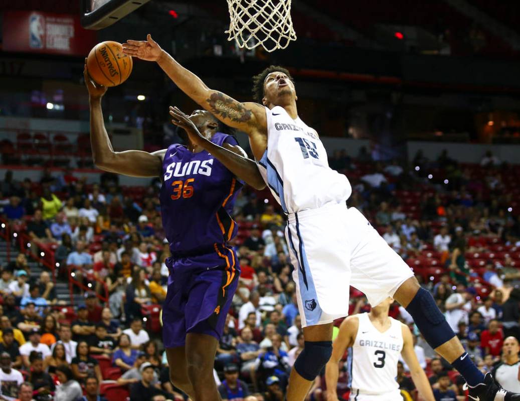 Memphis Grizzlies' Brandon Clarke (15) goes for a rebound against Phoenix Suns' Landry Nnoko (3 ...