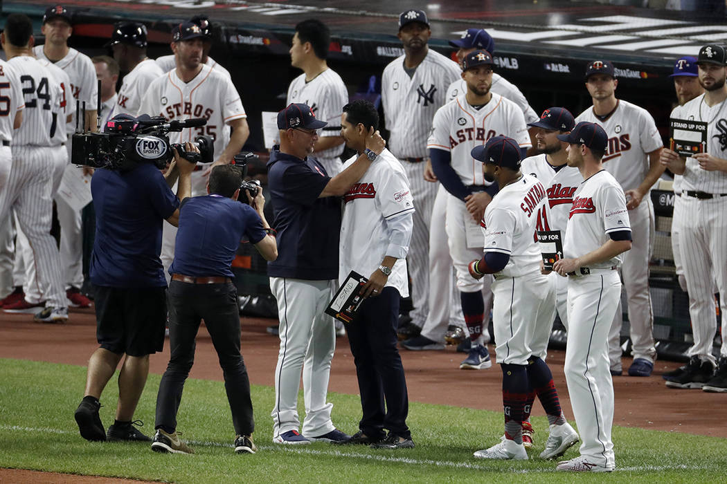 Cleveland Indians manager Terry Francona, left, hugs Indians pitcher Carlos Carrasco during the ...