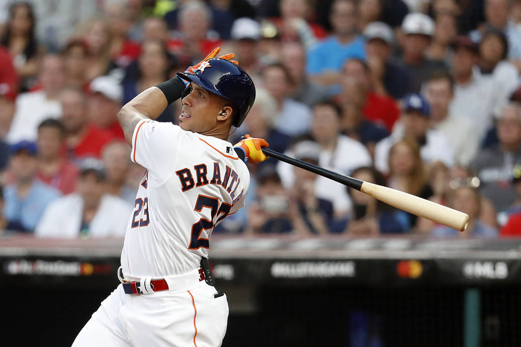 American League's Michael Brantley, of the Houston Astros, follows through on an RBI double dur ...