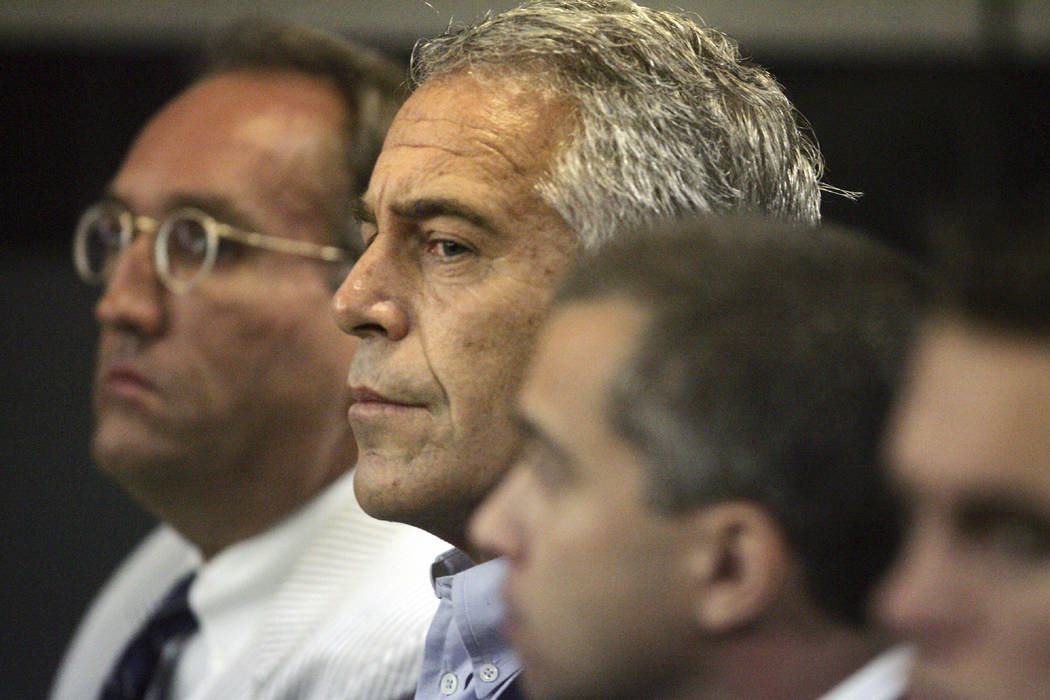 Jeffrey Epstein, center, appears in court July 30, 2008, in West Palm Beach, Fla. The wealthy f ...