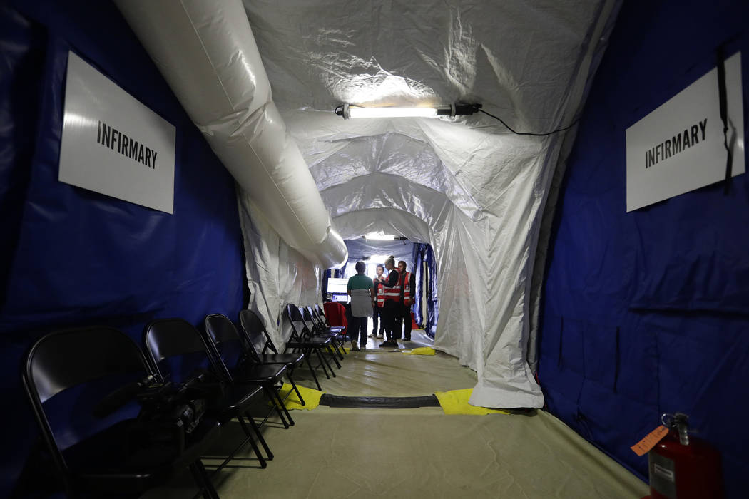 In this July 9, 2019, photo, an immigrant is attended to in the infirmary at the U.S. governmen ...