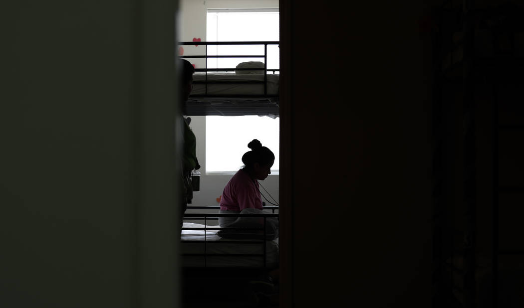 In this July 9, 2019, photo, an immigrant sits in her room at the U.S. government's newest hold ...