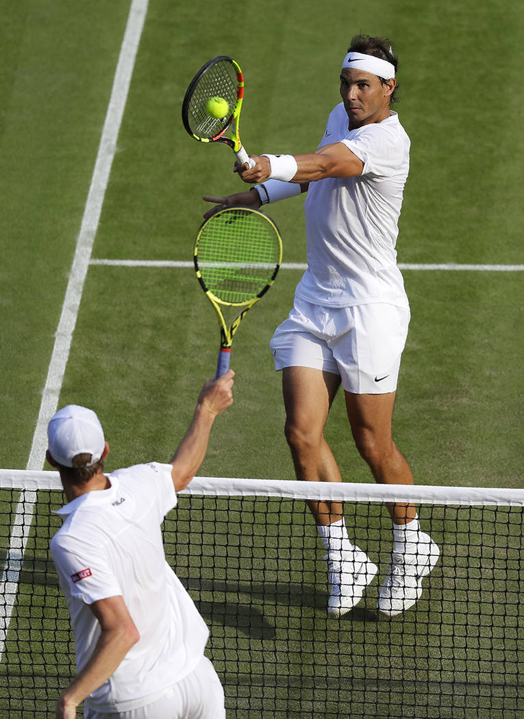 Spain's Rafael Nadal returns the ball during a men's quarterfinal match against United States' ...