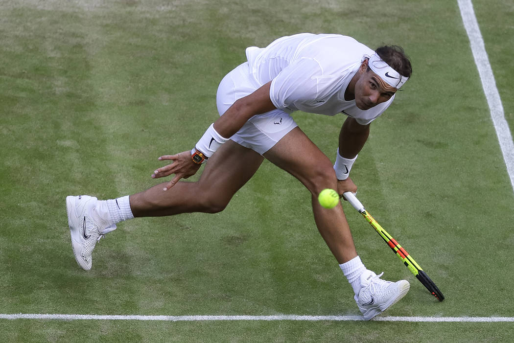 Spain's Rafael Nadal returns the ball during a men's quarterfinal match against United States' ...