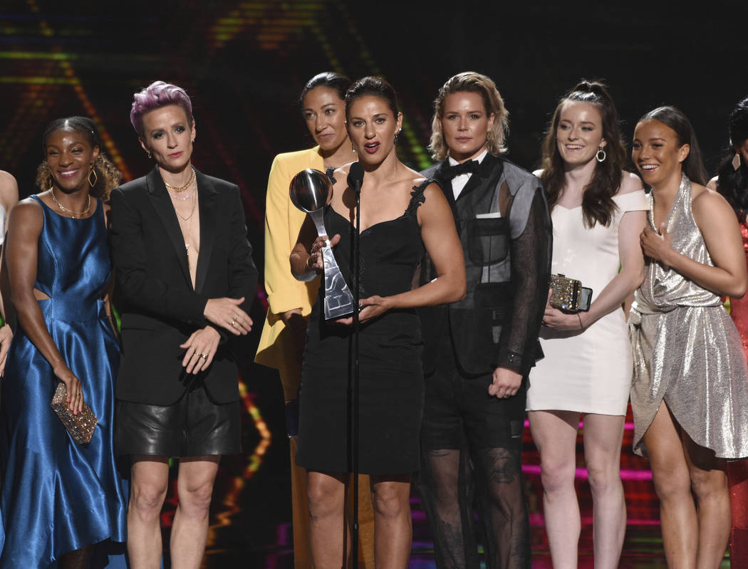 Carli Lloyd, center, and members of the U.S. women's national soccer team accept the award for ...