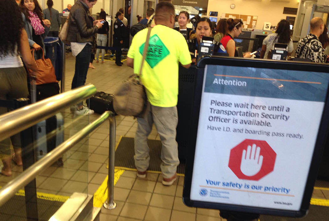 Passengers are screened by Transportation Security Administration workers at McCarran Internati ...